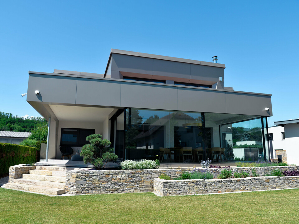 Garten und Terrasse eines Einfamilienhauses in Viehofen mit einer Gebäudehülle aus PREFA Aluminium